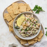 Tuna Chickpea Salad served with crackers and lemon slices.