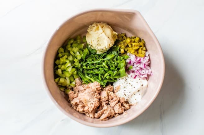 ingredients for tuna salad recipe added to a large mixing bowl