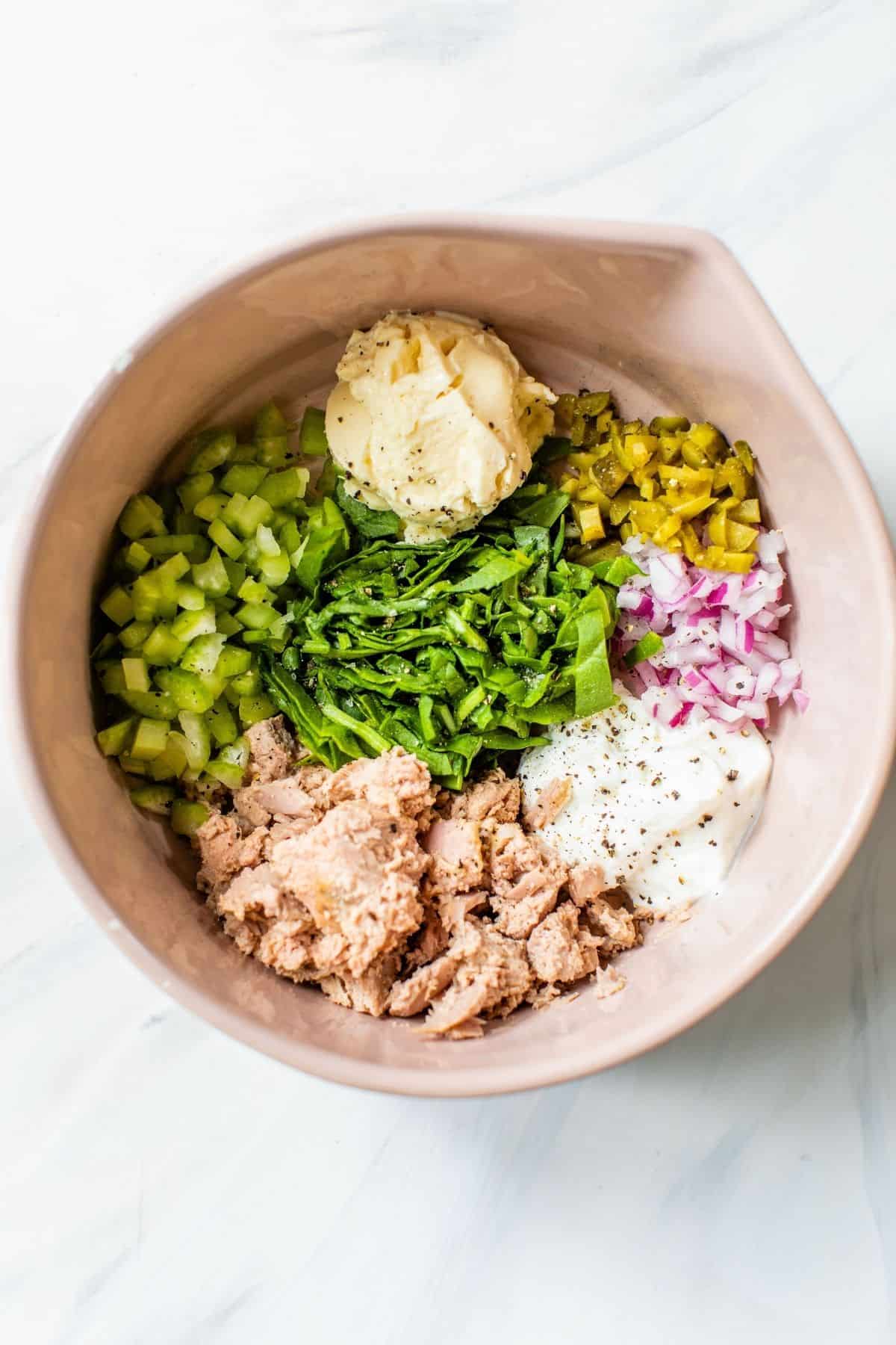 ingredients for tuna salad added to a large bowl