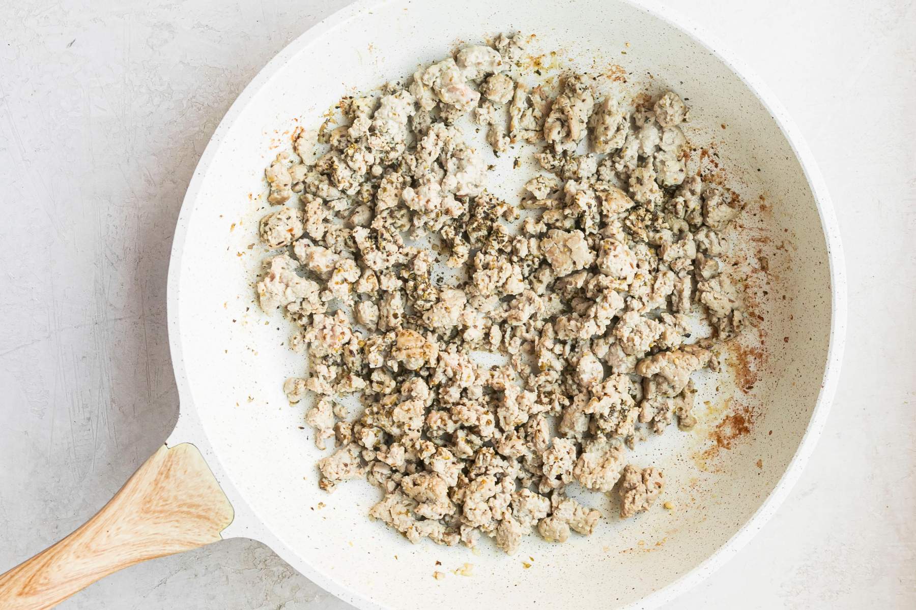 Cooking ground turkey in a skillet.