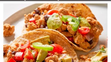 tacos topped with avocado and tomatoes