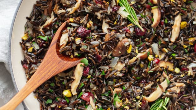 wild rice stuffing in a large white serving bowl